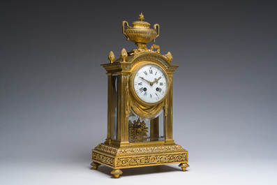 A French Louis XVI style gilt bronze and cut glass mantel clock accompanied by a pair of candlesticks, 19th/20th C.
