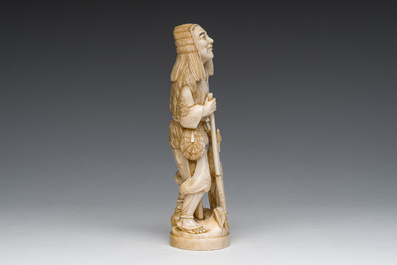 A Japanese ivory okimono of a hunter with his hunting trophy, signed, Meiji, ca. 1900