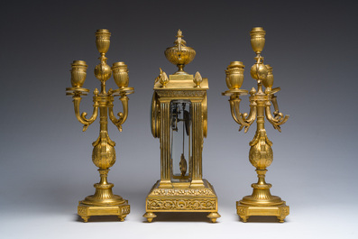 A French Louis XVI style gilt bronze and cut glass mantel clock accompanied by a pair of candlesticks, 19th/20th C.