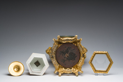 A Japanese polychrome three-piece garniture with ladies in a landscape mounted into a clock with richly gilt bronze mounts, 19th C.