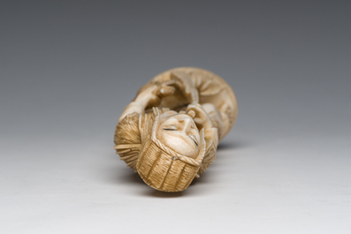 A Japanese ivory okimono of a hunter with his hunting trophy, signed, Meiji, ca. 1900