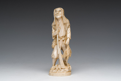 A Japanese ivory okimono of a hunter with his hunting trophy, signed, Meiji, ca. 1900