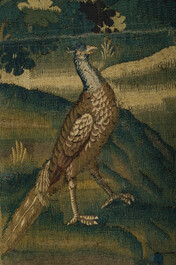 A Flemish wall tapestry with a pheasant in a landscape, 17th C.