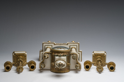 A French Louis XVI style three-piece gilt bronze mounted white marble clock garniture crowned with a flower basket, 19th C.
