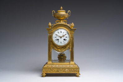 A French Louis XVI style gilt bronze and cut glass mantel clock accompanied by a pair of candlesticks, 19th/20th C.