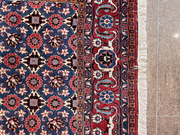A Persian Varamin rug with floral design, wool on cotton, mid 20th C.