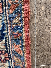 A Persian Sarouk rug with floral design, wool on cotton, first half 20th C.
