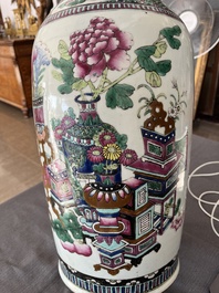 A Chinese famille rose and iron-red vase with a double design of antiquities and Buddhist lions, 19th C.