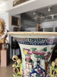 A Chinese famille rose and iron-red vase with a double design of antiquities and Buddhist lions, 19th C.