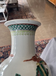A Chinese famille verte vase with Immortals and their servants in a palace garden, Kangxi mark, 19th C.