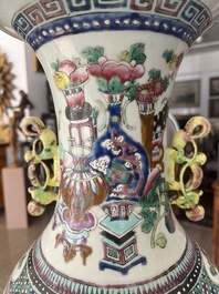 A Chinese famille rose and iron-red vase with a double design of antiquities and Buddhist lions, 19th C.