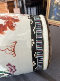 A Chinese famille rose and iron-red vase with a double design of antiquities and Buddhist lions, 19th C.