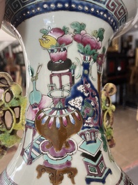 A Chinese famille rose and iron-red vase with a double design of antiquities and Buddhist lions, 19th C.