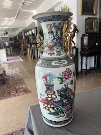 A Chinese famille rose and iron-red vase with a double design of antiquities and Buddhist lions, 19th C.