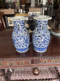 Two Chinese blue and white 'lotus scroll' vases with relief design, 19th C.
