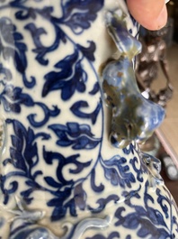 Two Chinese blue and white 'lotus scroll' vases with relief design, 19th C.