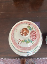 A pair of Chinese famille rose vases and covers with birds among blossoming branches, 19th C.