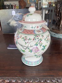 A pair of Chinese famille rose vases and covers with birds among blossoming branches, 19th C.