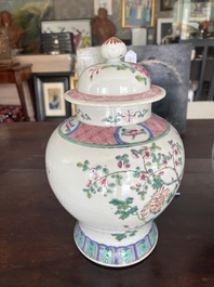 A pair of Chinese famille rose vases and covers with birds among blossoming branches, 19th C.