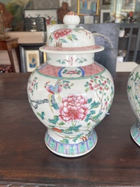 A pair of Chinese famille rose vases and covers with birds among blossoming branches, 19th C.