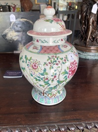 A pair of Chinese famille rose vases and covers with birds among blossoming branches, 19th C.
