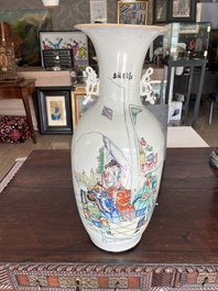 A pair of Chinese famille rose 'animated palace scene' vases, 19th/20th C.