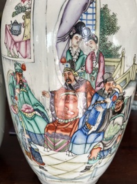A pair of Chinese famille rose 'animated palace scene' vases, 19th/20th C.