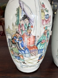 A pair of Chinese famille rose 'animated palace scene' vases, 19th/20th C.