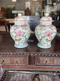 A pair of Chinese famille rose vases and covers with birds among blossoming branches, 19th C.