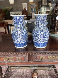 Two Chinese blue and white 'lotus scroll' vases with relief design, 19th C.
