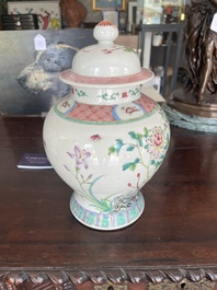 A pair of Chinese famille rose vases and covers with birds among blossoming branches, 19th C.