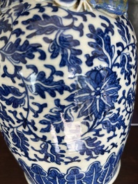 Two Chinese blue and white 'lotus scroll' vases with relief design, 19th C.