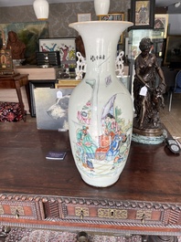 A pair of Chinese famille rose 'animated palace scene' vases, 19th/20th C.