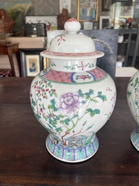 A pair of Chinese famille rose vases and covers with birds among blossoming branches, 19th C.