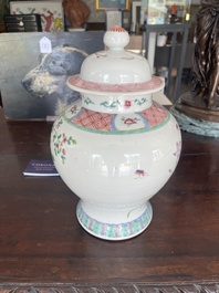 A pair of Chinese famille rose vases and covers with birds among blossoming branches, 19th C.