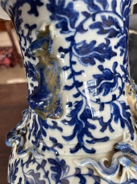 Two Chinese blue and white 'lotus scroll' vases with relief design, 19th C.