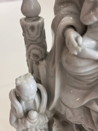 A Chinese Dehua blanc de Chine figure of Guanyin with servants, 19th C.