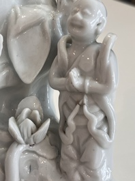 A Chinese Dehua blanc de Chine figure of Guanyin with servants, 19th C.