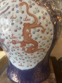 A pair of large Chinese famille rose blue-ground 'dragons and phoenixes' vases and covers, Kangxi mark, 19th C.