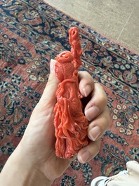 A Chinese red coral group with the 'Star God' Shou Xing and a lady, 19th/20th C.