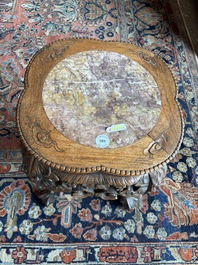A Chinese openworked carved wooden stand with marble top, 19th/20th C.