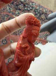 A Chinese red coral group with the 'Star God' Shou Xing and a lady, 19th/20th C.