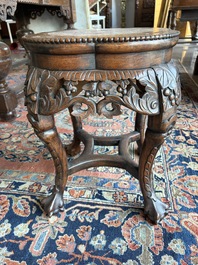 A Chinese openworked carved wooden stand with marble top, 19th/20th C.
