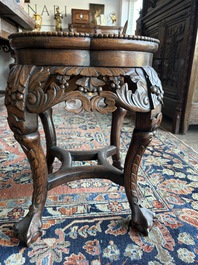 A Chinese openworked carved wooden stand with marble top, 19th/20th C.
