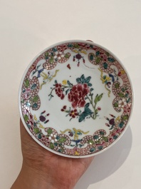 Six Chinese famille rose and gilt cups and saucers and a cream jug with floral and mandarin design, Yongzheng/Qianlong