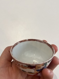 Six Chinese famille rose and gilt cups and saucers and a cream jug with floral and mandarin design, Yongzheng/Qianlong