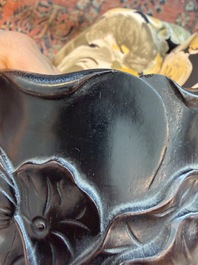 A Chinese ebonized wooden brush pot with relief design of lotus flowers and an inscription, 20th C.