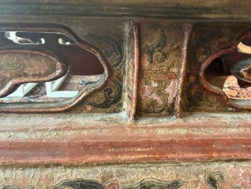 A Chinese rectangular carved and lacquered wooden low table with peach design, Qing