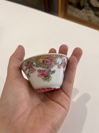 Six Chinese famille rose and gilt cups and saucers and a cream jug with floral and mandarin design, Yongzheng/Qianlong