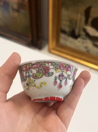 Six Chinese famille rose and gilt cups and saucers and a cream jug with floral and mandarin design, Yongzheng/Qianlong